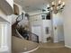 Spacious foyer featuring a spiral staircase with rod iron spindles and neutral finishes at 16401 S 29Th Dr, Phoenix, AZ 85045