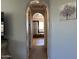 Hallway view leading to the bathroom featuring an archway and neutral wall color at 16401 S 29Th Dr, Phoenix, AZ 85045