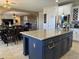 Open concept kitchen with a large kitchen island, stone countertops, and stainless steel appliances at 16401 S 29Th Dr, Phoenix, AZ 85045