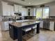 A well-appointed kitchen featuring white cabinetry, a central island with seating, and granite countertops at 16401 S 29Th Dr, Phoenix, AZ 85045