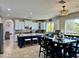 Bright, open floor plan showcasing a modern kitchen and dining area with backyard views at 16401 S 29Th Dr, Phoenix, AZ 85045