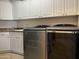 Functional laundry room with ample cabinet space, a utility sink, and modern washing machines at 16401 S 29Th Dr, Phoenix, AZ 85045