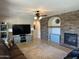 Cozy living room features a stone fireplace, large television, and ample seating space at 16401 S 29Th Dr, Phoenix, AZ 85045