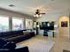 Cozy living room features a stylish ceiling fan and large windows with outdoor views at 16401 S 29Th Dr, Phoenix, AZ 85045