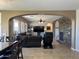 Open-concept living room with a stone fireplace and a large sectional sofa, connecting to the kitchen at 16401 S 29Th Dr, Phoenix, AZ 85045