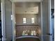 Bright loft with a decorative chandelier, railing, and neutral colored walls at 16401 S 29Th Dr, Phoenix, AZ 85045