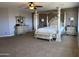 Elegant main bedroom featuring a four-poster bed, dresser, and soft lighting at 16401 S 29Th Dr, Phoenix, AZ 85045
