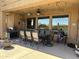 Covered patio dining area featuring a grill, an outdoor kitchen, and backyard views at 16401 S 29Th Dr, Phoenix, AZ 85045