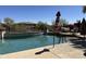 A backyard pool with a lounge area, palm trees, and desert landscaping at 16401 S 29Th Dr, Phoenix, AZ 85045