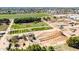 Aerial view of a farm venue with outdoor attractions and event space, set against residential surroundings at 1705 E Juanita Ave, Mesa, AZ 85204