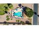 Aerial view of community pool surrounded by palm trees and lounge chairs, offering a serene retreat at 1705 E Juanita Ave, Mesa, AZ 85204