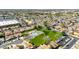 High aerial view of a neighborhood park with a pool, playground, and ample green recreational space at 1705 E Juanita Ave, Mesa, AZ 85204