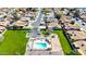 Aerial view of a neighborhood featuring a community pool, playground, and ample green space at 1705 E Juanita Ave, Mesa, AZ 85204