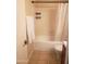 Bright bathroom features a shower-tub combo and a white shower curtain at 1705 E Juanita Ave, Mesa, AZ 85204