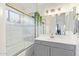 Well-lit bathroom featuring a shower-tub combination, modern vanity, and stylish fixtures for a refreshing and clean space at 1705 E Juanita Ave, Mesa, AZ 85204