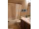 Cozy bathroom featuring a shower-tub combo and neutral-toned tile surround at 1705 E Juanita Ave, Mesa, AZ 85204