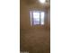 Bright bedroom featuring neutral walls, carpeted floors, and natural light from the window at 1705 E Juanita Ave, Mesa, AZ 85204