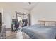 Comfortable bedroom with a dedicated workspace, featuring a modern desk setup by a sunny window and cozy bed at 1705 E Juanita Ave, Mesa, AZ 85204