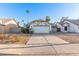 Traditional home with a two-car garage and desert landscaping under a clear blue sky at 1705 E Juanita Ave, Mesa, AZ 85204