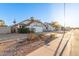 Single-story home with a two-car garage, drought-resistant landscaping, and a gable-roof design at 1705 E Juanita Ave, Mesa, AZ 85204