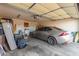 Organized garage featuring ample storage space and a modern vehicle, offering both functionality and convenience at 1705 E Juanita Ave, Mesa, AZ 85204