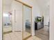 Hallway view of bedroom and bathroom featuring closet with mirrored doors at 1705 E Juanita Ave, Mesa, AZ 85204