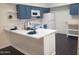 Bright kitchen with white countertops, stainless appliances, and blue cabinets offering storage at 1705 E Juanita Ave, Mesa, AZ 85204
