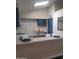 Well lit kitchen featuring stainless appliances, white countertops and blue cabinets at 1705 E Juanita Ave, Mesa, AZ 85204