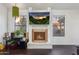Bright living room with a modern fireplace, a flat-screen TV, and large windows that fill the space with natural light at 1705 E Juanita Ave, Mesa, AZ 85204