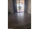 Living room featuring hardwood flooring, sliding glass door to patio, and natural light at 1705 E Juanita Ave, Mesa, AZ 85204