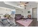 Bright living room with hardwood floors and furniture; open to the kitchen and dining area at 1705 E Juanita Ave, Mesa, AZ 85204