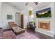 Cozy living room with a fireplace, mounted television, and stylish decor at 1705 E Juanita Ave, Mesa, AZ 85204