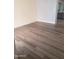 Open concept living space with wood-look flooring and light-colored walls creating an airy atmosphere at 1705 E Juanita Ave, Mesa, AZ 85204