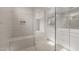 Modern bathroom featuring a glass shower with a built in bench and double sink vanity at 17614 W Palo Verde Dr, Litchfield Park, AZ 85340