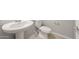Half-bathroom features a pedestal sink, modern fixtures, and neutral finishes, providing a clean and functional space at 17614 W Palo Verde Dr, Litchfield Park, AZ 85340