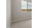 Neutral carpeted bedroom featuring bright walls and a window with a view of the community at 17614 W Palo Verde Dr, Litchfield Park, AZ 85340