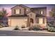 Charming two-story home features a welcoming facade, lush landscaping, and a convenient two-car garage at 17614 W Palo Verde Dr, Litchfield Park, AZ 85340