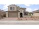 Inviting two-story home showcases a brick-paved driveway, a tiled roof, and a charming gated front entryway at 17614 W Palo Verde Dr, Litchfield Park, AZ 85340