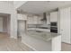 Bright kitchen boasts white cabinetry, granite countertops, stainless appliances, and a large center island at 17614 W Palo Verde Dr, Litchfield Park, AZ 85340
