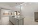 Bright, open kitchen featuring a large island with granite countertops and a view into the living area at 17614 W Palo Verde Dr, Litchfield Park, AZ 85340