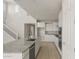 Kitchen features white cabinetry, granite countertops, and stainless appliances, complemented by a staircase at 17614 W Palo Verde Dr, Litchfield Park, AZ 85340