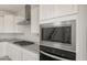 Well-equipped kitchen with stainless steel appliances, granite countertops, and white cabinets for a modern cooking experience at 17614 W Palo Verde Dr, Litchfield Park, AZ 85340
