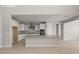 Open kitchen features white cabinets, granite counters, an island, and stainless-steel appliances for modern living at 17614 W Palo Verde Dr, Litchfield Park, AZ 85340