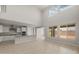 Bright and airy living room with high ceilings, lots of natural light, tiled floors, and an open layout at 17614 W Palo Verde Dr, Litchfield Park, AZ 85340