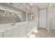 A bright ensuite bathroom featuring a walk-in shower and dual sinks and an oversized mirror at 17614 W Palo Verde Dr, Litchfield Park, AZ 85340