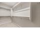 Spacious walk-in closet with multiple shelves and rack storage for clothes and accessories at 17614 W Palo Verde Dr, Litchfield Park, AZ 85340
