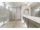 Bathroom featuring dual sinks, modern vanity, and separate glass-enclosed shower at 17633 W Palo Verde Dr, Litchfield Park, AZ 85340