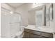 Bathroom featuring a glass-enclosed shower, toilet, vanity with countertop and cabinet storage, and large mirror at 17633 W Palo Verde Dr, Litchfield Park, AZ 85340