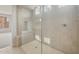 Spacious walk-in shower with tile surround, bench, and natural lighting at 17633 W Palo Verde Dr, Litchfield Park, AZ 85340