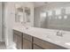 Bathroom featuring double sinks with a quartz countertop and modern fixtures at 17633 W Palo Verde Dr, Litchfield Park, AZ 85340